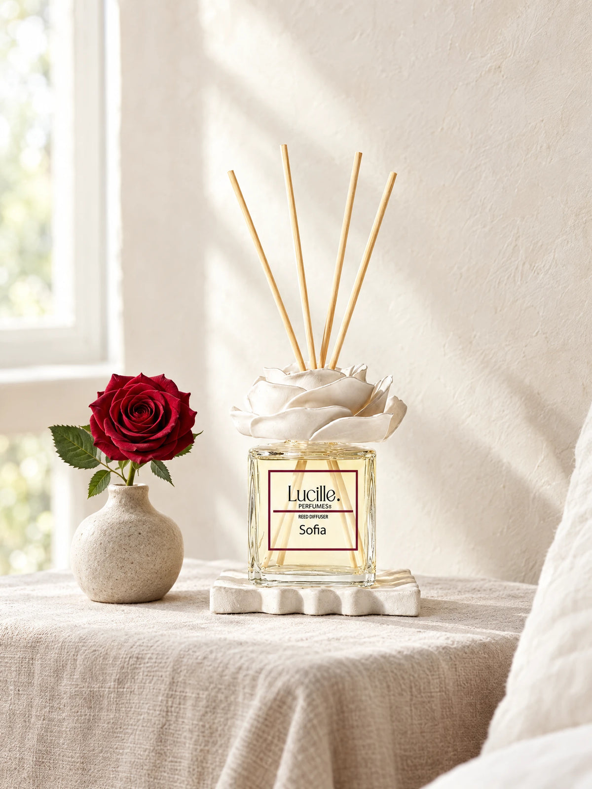 Sofia 200 ml on linen beside a red rose, styled with optional gypsum flower and plate accessories